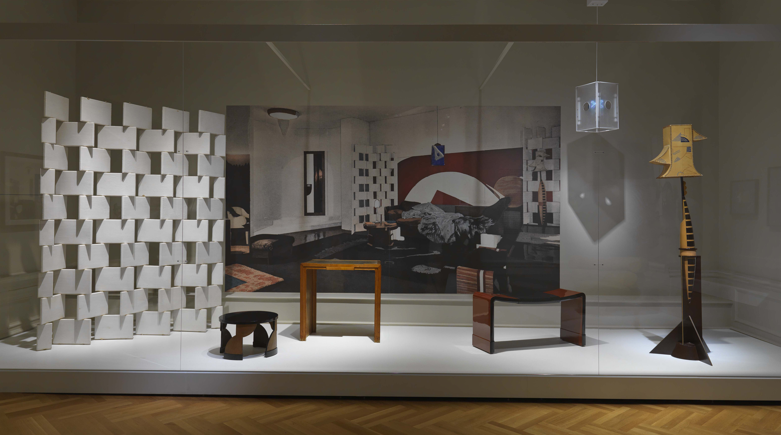 Exhibition case of Gray's screen, 2 tables, bench, and 2 lamps for the 1923 Bedroom/Boudoir for Monte Carlo installation.