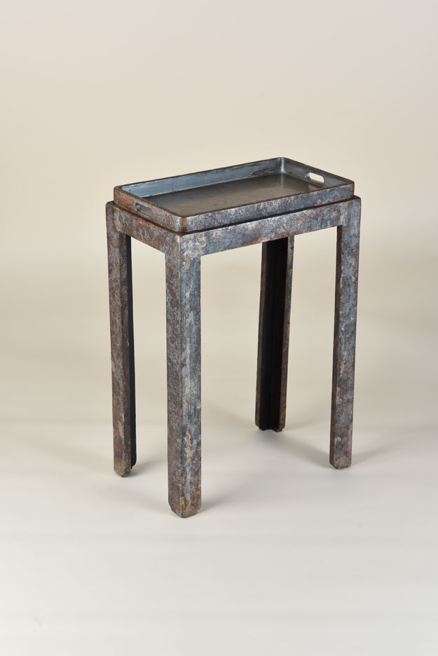 Installation image of a small blue and gray lacquered tea table.
