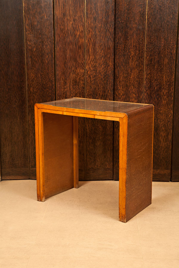 Photograph of a small simple wooden table.