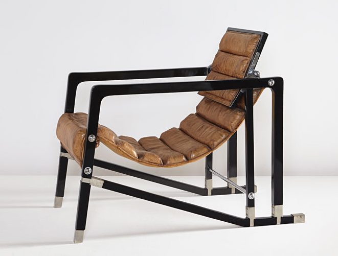 Installation image of a tan leather and black metal arm chair.