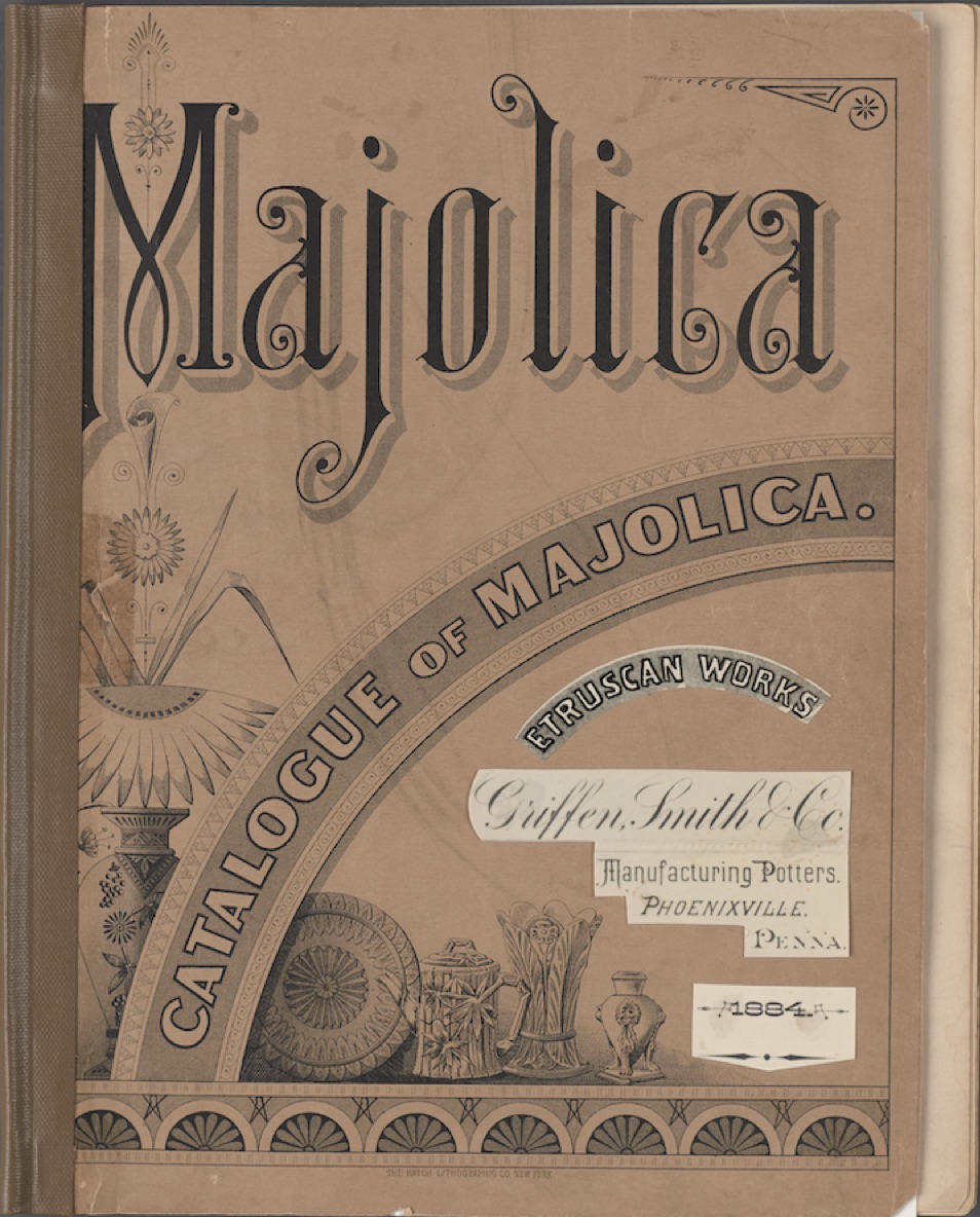 Black-and-white Griffen Smith & Co. Majolica catalogue cover. "Majolica in large text on top half, images of majolica on lower half with arched text reading "Catalogue of Majolica." Pasted cutouts of white paper with black text on lower right.