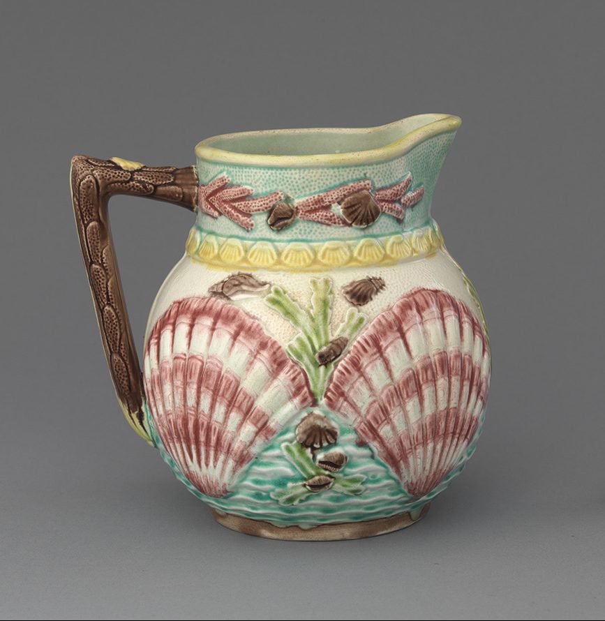Majolica "marine" jug with striped scallop shell motif, smaller shell and coral motifs, on turquoise and white ground with brown and yellow details.