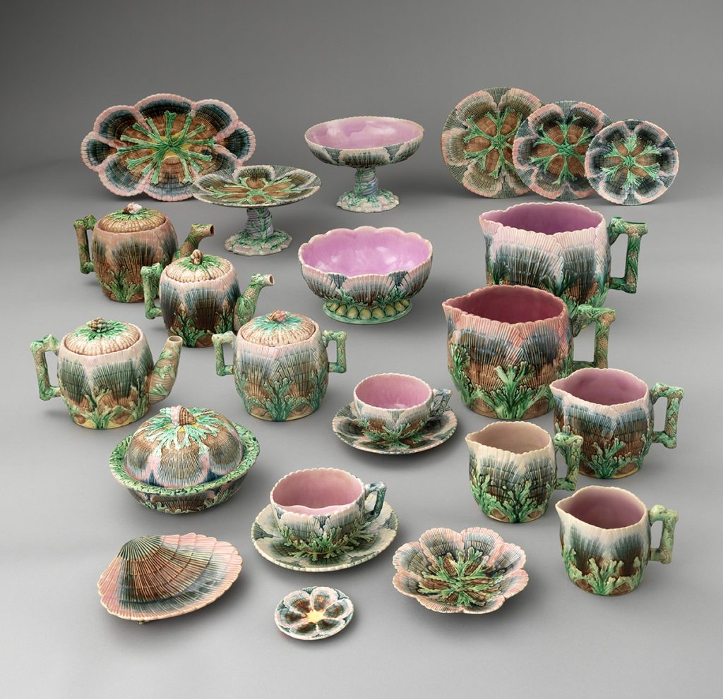 Majolica "Shell" ware set of assorted green and pink wares including plates, comports, jugs, teapots, and covered dishes.