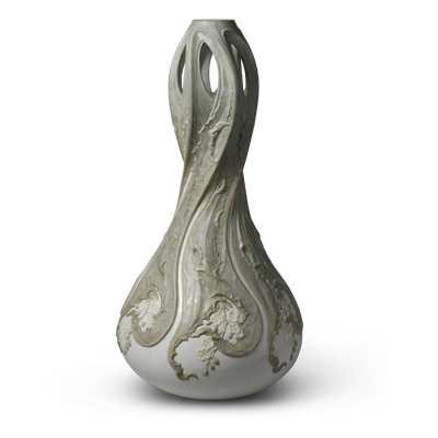 A tall, white ceramic vase with an elegant, elongated teardrop shape. It features intricate, raised vine and floral patterns with a distressed, vintage look. The vase has openwork detailing at the top, creating a delicate, airy aesthetic.