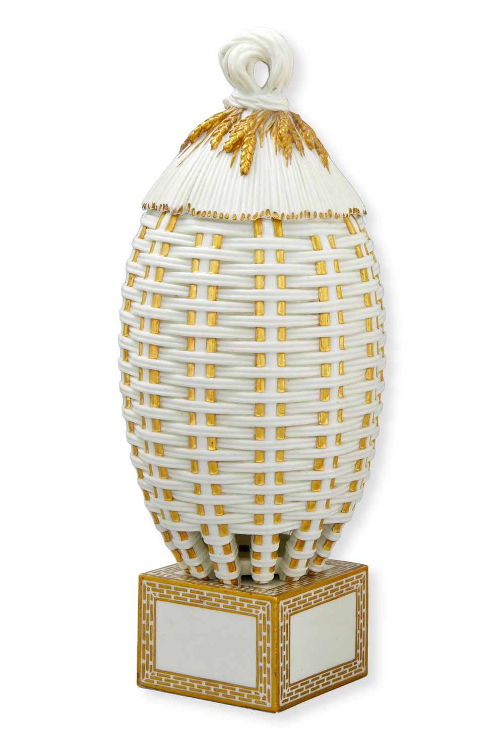 A decorative, egg-shaped sculpture with a white, woven texture and gold accents on a square base. The top resembles a ribbon knot, and the overall look suggests an intricately designed, elegant piece of art. The background is solid black.