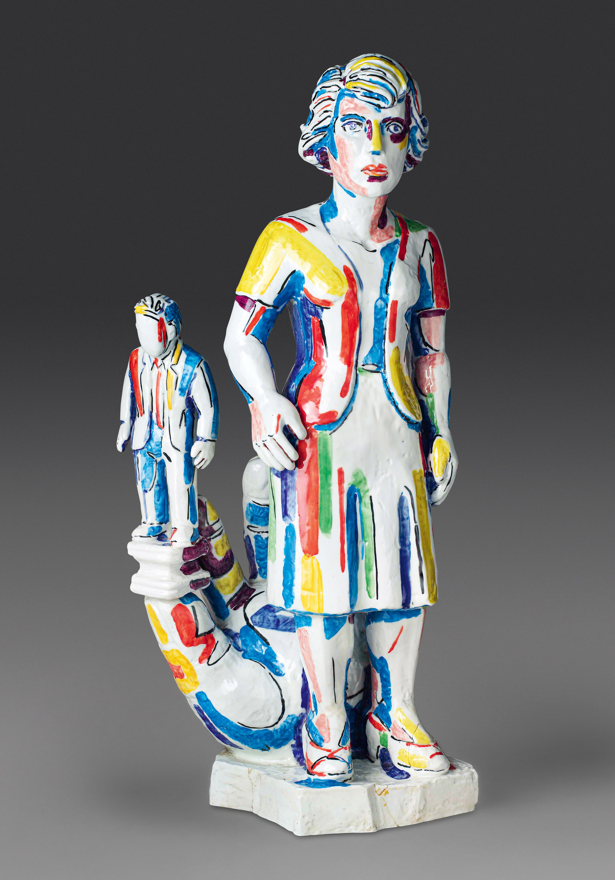 A colorful ceramic sculpture of a woman adorned with abstract, multicolored streaks of red, blue, yellow, and green. On her left, a smaller, similarly styled figure stands connected by a flowing structure, with a neutral gray background.