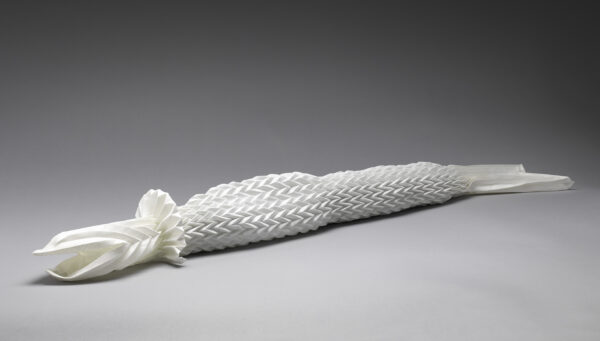 An intricate napkin sculpture depicting a fish.