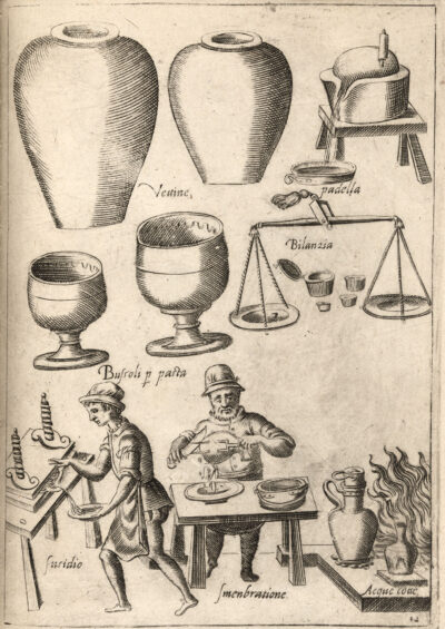A black and white Illustration depicting various kitchen vessels at the top and two men performing tasks below. One figure is carving an animal carcass with a fork and knife, slicing the meat into a dish, and the other catches a liquid in a dish running off of a table. Both men stand next to several vessels placed in a wood burning fire. Text in Italian labels the items and activities.