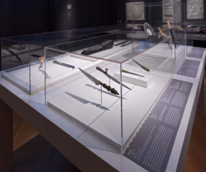 Detail of the Carving by the Book section of the "Staging the Table in Europe 1500-1800" exhibition, featuring multiple display cases with carving tools.